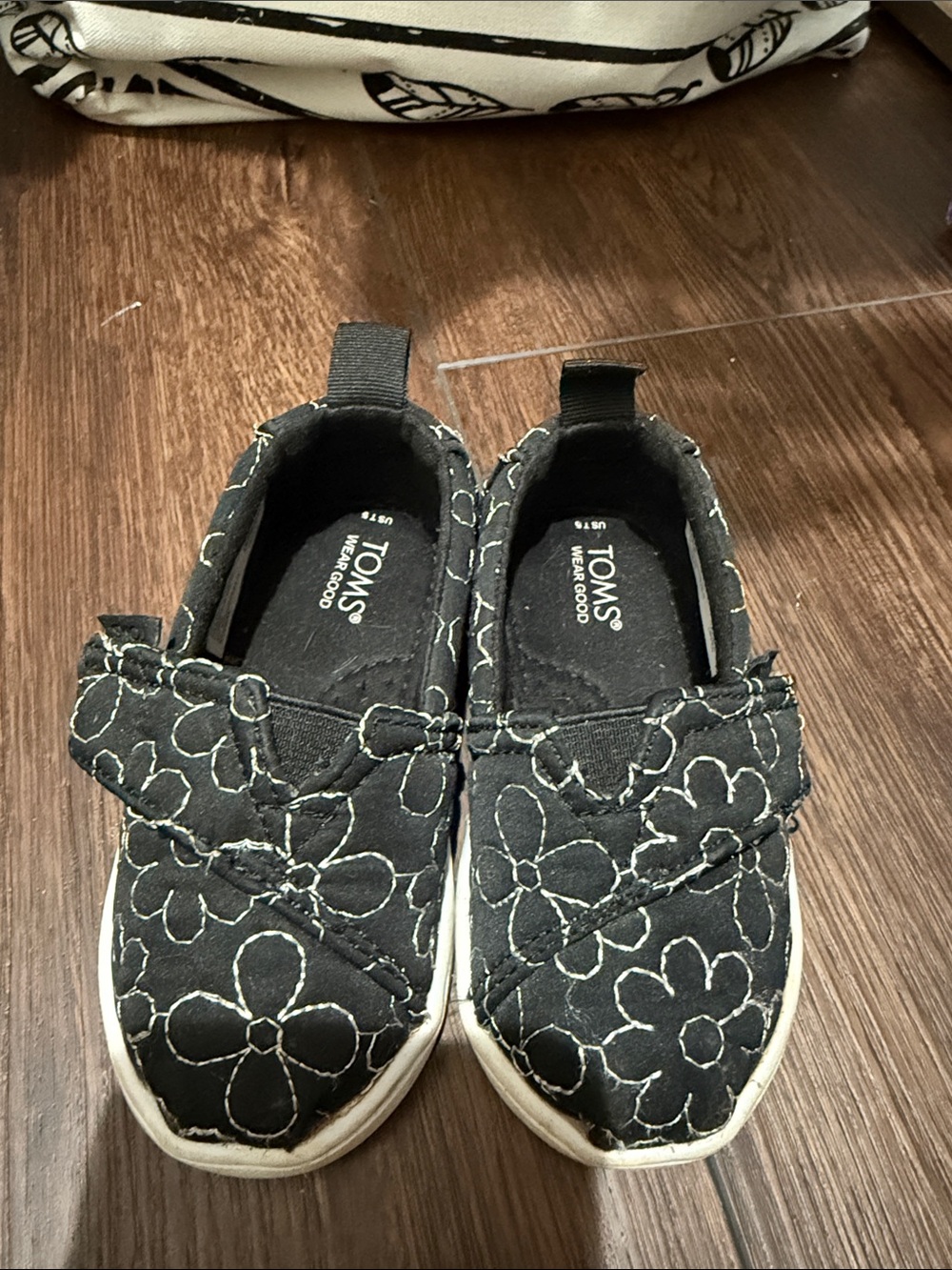 TOMS Kids Black Slip-On Shoes with White Floral Stitching